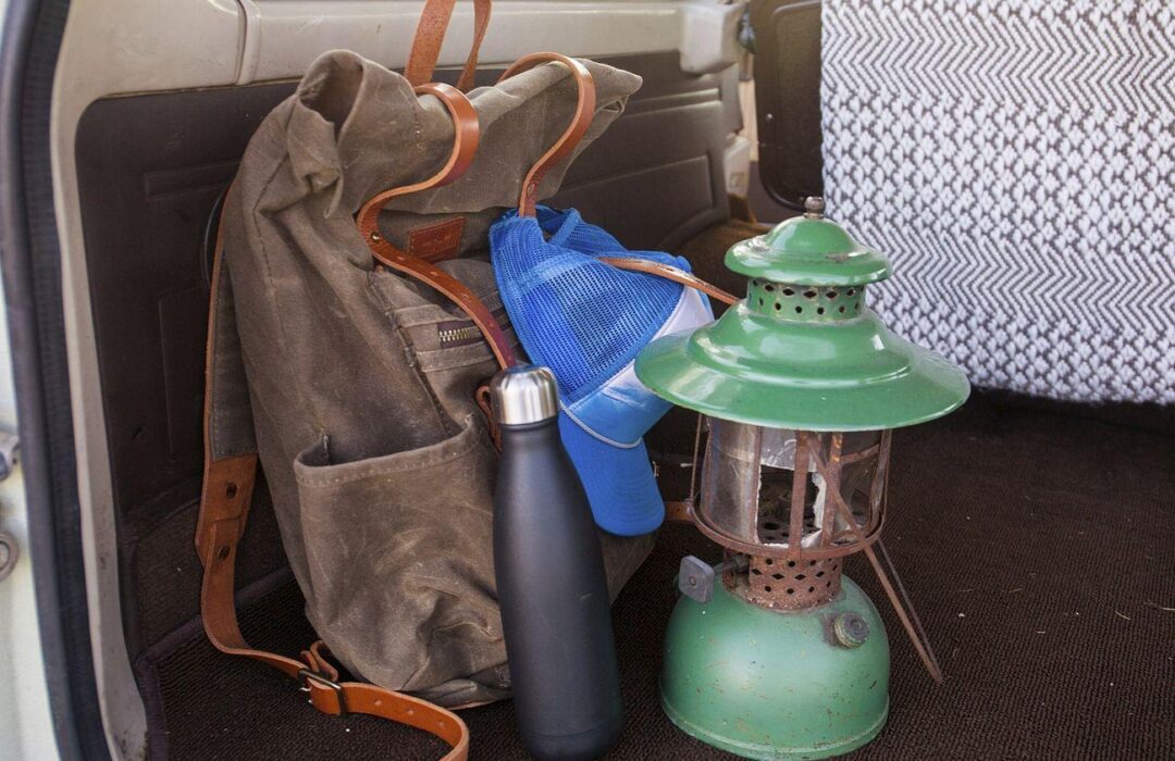 Free backpack hiking gear image - a backpack and a lantern in the back of a car