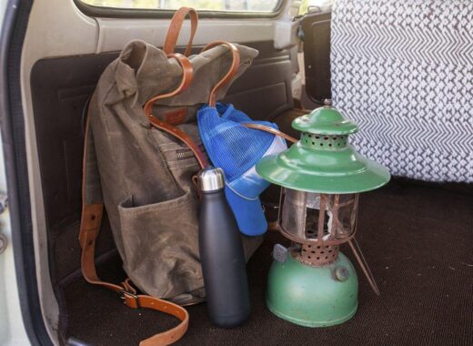 Free backpack hiking gear image - a backpack and a lantern in the back of a car